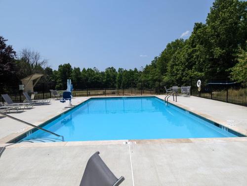 a large blue swimming pool in a yard at Candlewood Suites Aberdeen-Bel Air by IHG in Riverside