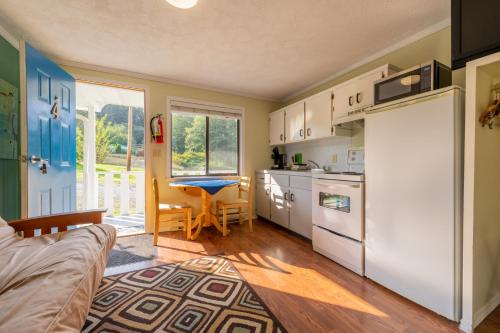 a kitchen with a refrigerator and a table at The Cabins at Alert Bay in Alert Bay