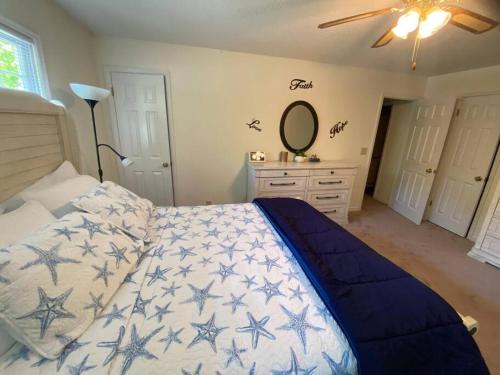 a bedroom with a bed and a dresser and a mirror at Your Own Lakehouse in Macon