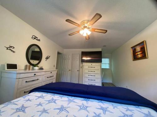 a bedroom with a bed and a ceiling fan at Your Own Lakehouse in Macon