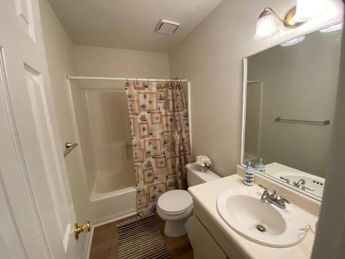 a bathroom with a sink and a toilet and a shower at Your Own Lakehouse in Macon