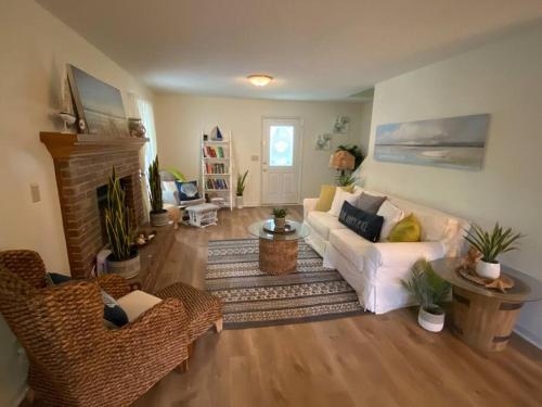 a living room with a white couch and a fireplace at Your Own Lakehouse in Macon