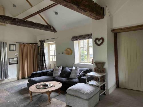 a living room with a couch and a table at New luxury self-contained studio in South Cadbury