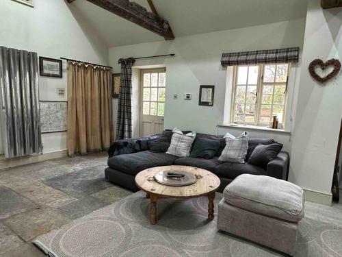 a living room with a couch and a coffee table at New luxury self-contained studio in South Cadbury