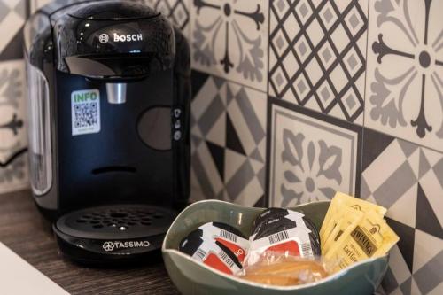 a bowl of food sitting next to a coffee maker at COSY FLAT direct access Genève-Airport-Palexpo in Annemasse