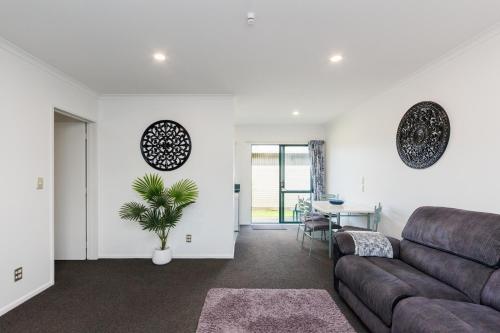 a living room with a couch and a table at Camelot Motor Lodge and Conference Centre in Palmerston North
