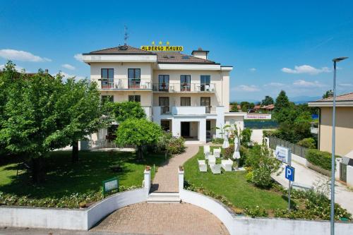 a building with a brick walkway in front of it at Hotel Arya by Mauro in Sirmione