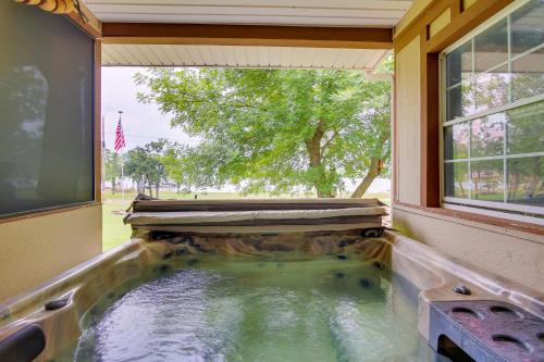 a pool of water in a house with a window at Cozy Lake Eufaula Hideaway with Fire Pit and Hot Tub! in Eufaula