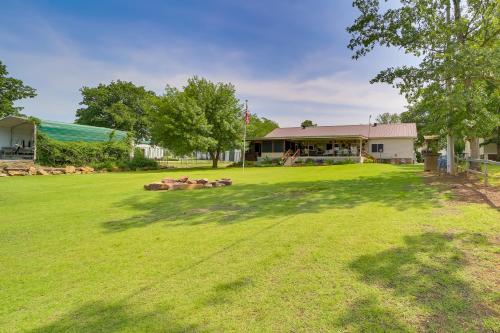 a large yard in front of a building at Cozy Lake Eufaula Hideaway with Fire Pit and Hot Tub! in Eufaula