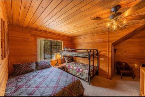 a bedroom with a bunk bed in a wooden cabin at Cabin #1 Buffalo Herd -Pet Friendly - Sleeps 6 - Playground & Game Room in Payson