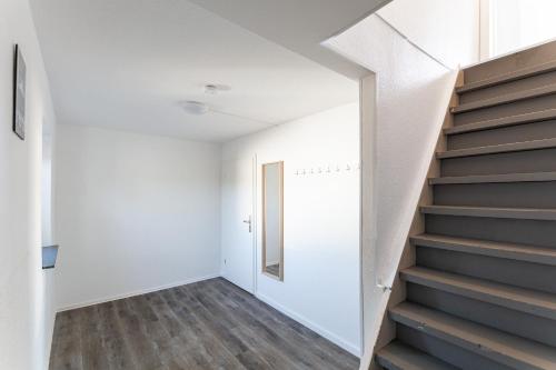a staircase in a house with white walls and a stair case at T&K Apartments Wegberg 5 Monteur Apartments in Wegberg