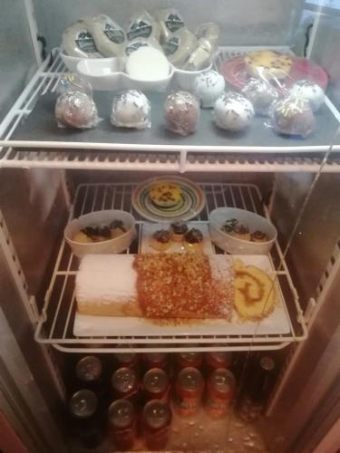 a refrigerator filled with lots of different types of food at CaminAndes Hostal in San Pedro de Atacama