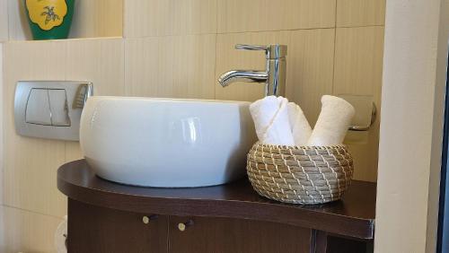 a bathroom with a sink and towels on a counter at ATCA House in Bucharest