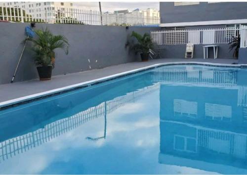 a large blue swimming pool on top of a building at STARFISH LUXURY APARTMENT in San Juan