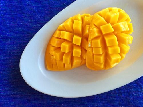 a mango cut in half on a white plate at Casa Cayuco Eco-Adventure Lodge in Bocas del Toro