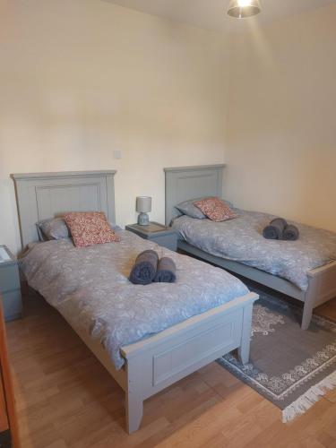 a bedroom with two beds with shoes on them at Castle Chalets in Cork