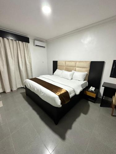 a bedroom with a large bed in a room at Maxx Msquare Hotel in Agege