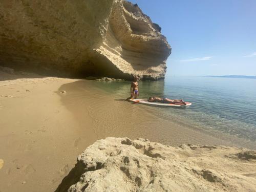 a man standing on a boat on the beach at b&b Casa Balai 72 a 100 mt dal mare in Porto Torres