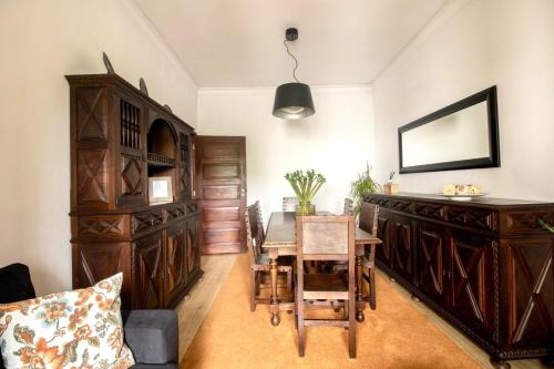 una sala da pranzo con tavolo e mobili in legno di Apartamento do Arquinho I - by VinteOito ad Amarante