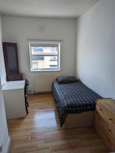 a bedroom with a bed and a window at Oldham town centre rm03 in Oldham