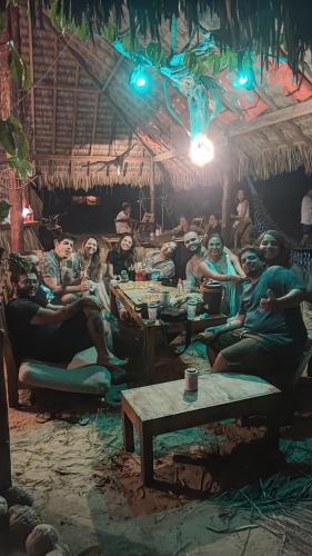 grupa ludzi siedzących w pokoju w obiekcie Pousada Amor Do Arpoador w mieście Tutóia