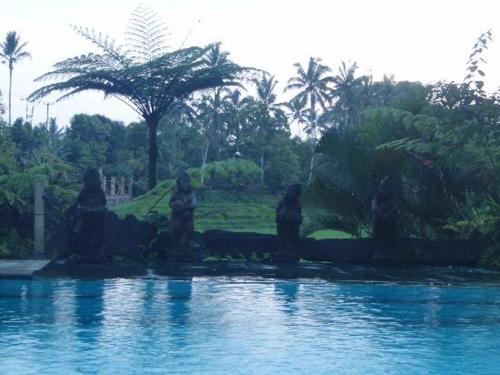 a fountain in a park with statues in the water at Cempaka Belimbing Villa in Blimbing