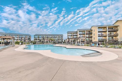 a swimming pool in the middle of a apartment complex at Ocean View & Easy Beach Access! in Surf City