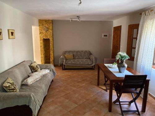 a living room with a couch and a table at Agia Paraskevi Villa Olive in Mákri