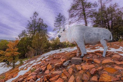 a statue of a cow on top of a mountain at Cabin#2 Elk Hallow - Pet Friendly - Sleeps 6 - Playground & Game Room in Payson