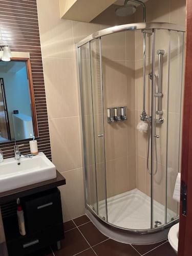 a bathroom with a shower and a sink at AS CEGONHAS - ALOJAMENTo LOCAL in Olhão