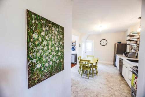 a kitchen and a dining room with a painting on the wall at The Kitch'inn - Boutique Inn and Wine Bar in Mahone Bay