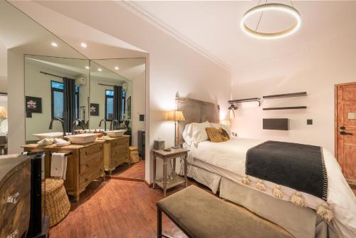 a bedroom with a large bed and a bathroom at Orchid House Mexico City in Mexico City