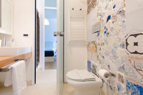 a bathroom with a toilet and a sink at Villa Zagara Garden Spectacular Sea View in Taormina in Taormina
