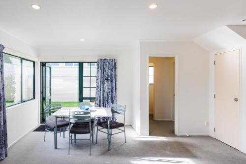 a dining room with a table and chairs at Camelot Motor Lodge and Conference Centre in Palmerston North
