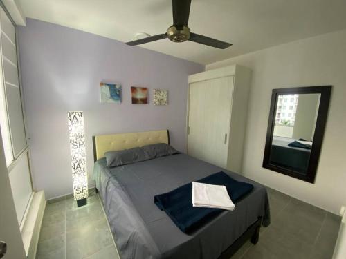 a bedroom with a bed and a ceiling fan at Apto nuevo en Girardot, piscina, BBQ, terraza. in Girardot