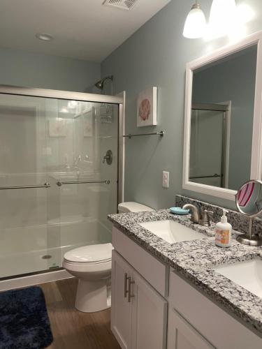 a bathroom with a shower and a toilet and a sink at Our Happy Place in Colonial Beach in Colonial Beach