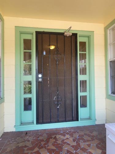 a screened door on a house with two windows at CLR St. Pete in St Petersburg