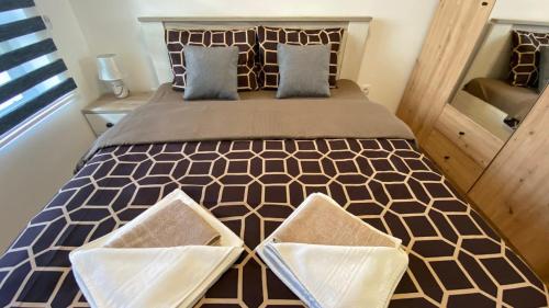 a bedroom with a large bed with two pillows at Apartman Ružica Sokobanja in Soko Banja