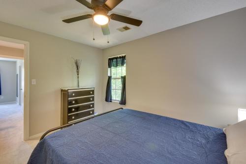 a bedroom with a blue bed and a ceiling fan at Seneca Vacation Rental Less Than 1 to Lake Keowee Access! in Seneca