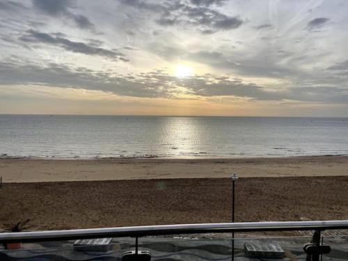a view of the beach with the sun setting at Royal Sands Ramsgate - direct beach access in Ramsgate