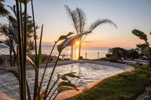 a swimming pool with the ocean in the background at Villa Zagara Garden Spectacular Sea View in Taormina in Taormina