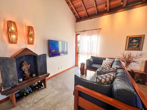 a living room with two couches and a tv at Oceà Privilegi - Taipu de Fora in Barra Grande