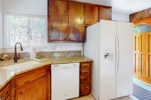 a kitchen with a white refrigerator and wooden cabinets at Rocky Pines in Twin Peaks