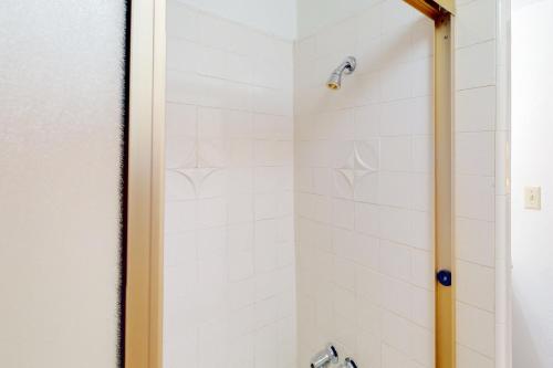 a bathroom with a shower with white tiles at Rocky Pines in Twin Peaks