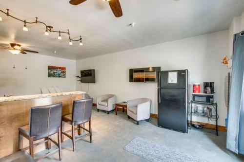 a room with a bar with chairs and a kitchen at Central Lava Hot Springs Studio with Deck and Views! in Lava Hot Springs