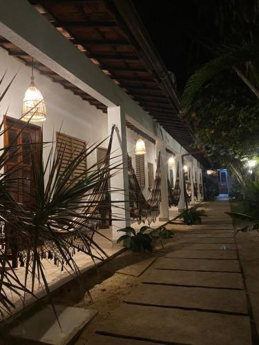 a building with a bunch of plants on the side of it at Pousada Pedra Furada in Jericoacoara