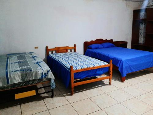 two beds sitting in a room with at Residencial RM in Puerto Francisco de Orellana