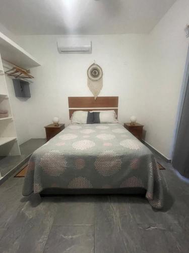 a bedroom with a bed and two night stands at Centrico Departamento (301) in Cancún