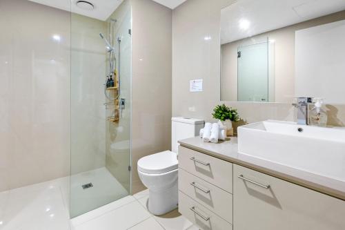 a bathroom with a toilet and a shower and a sink at Salt Five Apartment Sorrento - Main Street Location in Sorrento