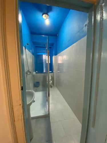 a bathroom with two sinks and a blue ceiling at Lisbon Bangla in Lisbon